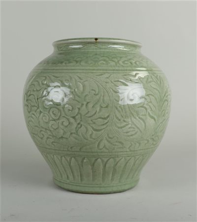 A celadon vase with floral decoration. China, 19th century.25 x 25 cm.
