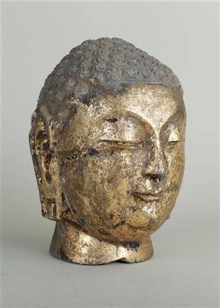 A stone partly gilded partly Buddha head, hair has remains of polychrome....
