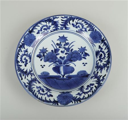 A porcelain dish with a decoration of a vase and flowers. Japan, 17th...