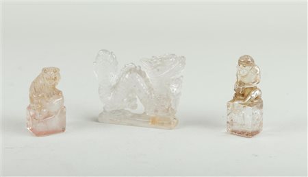 A lot of mountain crystal objects consisting of a dragon and two stamps with...