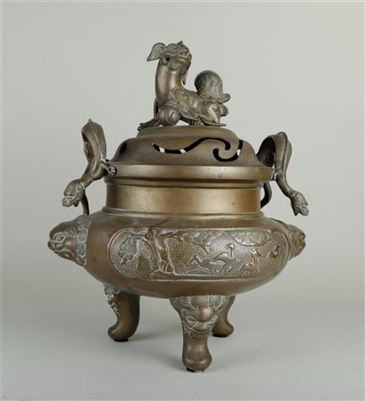 A large bronze incense burner decorated with deer and birds in a landscape...
