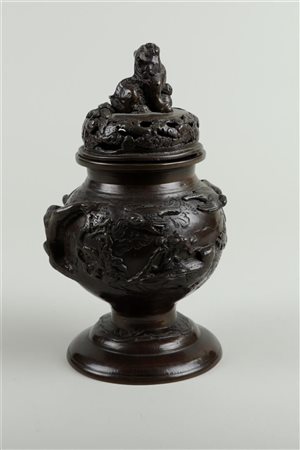 A bronze incense burner decorated with birds and a foo-dog on lid, marked on...