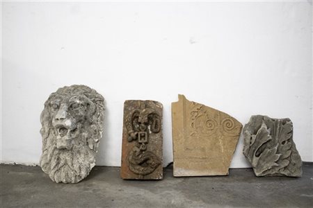 Lotto composto da un mascherone a testa leonina, due frammenti di fregio in ter