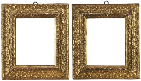 Coppia di cornici in legno intagliato e dorato a volute fogliate. Secolo XVII.