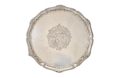 Salver in argento con bordura godronata e a volute fogliacee, piano inciso con