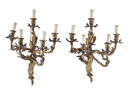 Coppia di appliques in bronzo dorato a cinque luci con bracci a volute fogliate