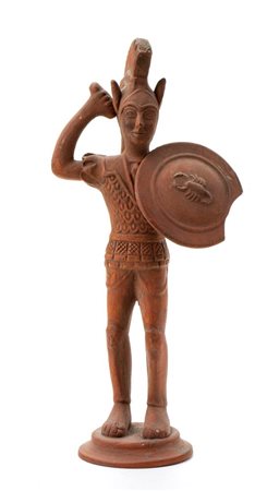 Scultura in terracotta raffigurante un guerriero etrusco con elmo, spada, scudo ed armatura   