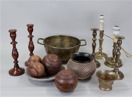 A lot of various antiques including candlesticks, cones and a mortar.