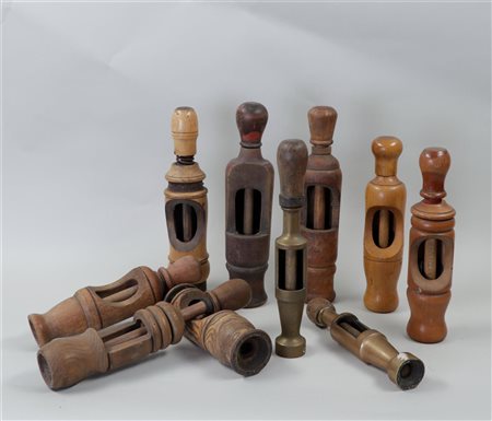 A collection of various wooden and brass corkscrews.