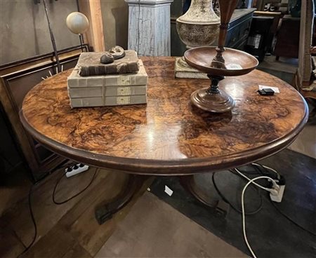 A Victorian coffee table with oval top covered with burl walnut veneer. Late...