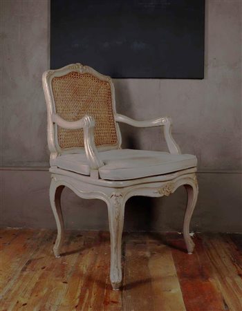 A grey lacquered Louis XV style armchair with fabric cushion. The back and...