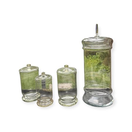 A lot of four large glass storage jars. H. 30 - 65 cm.