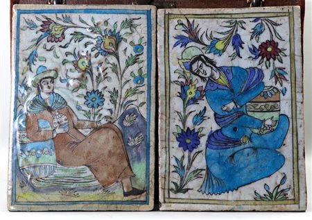 A set of two Iranian Qayar tiles with a decoration of courtiers. 25 x 32 cm.