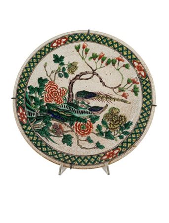 Piatto in porcellana decorato a smalti policromi con fiori e volatili (d cm 37)