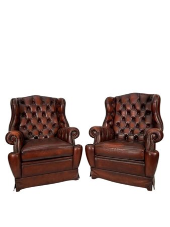 A lot of (2) tufted Chesterfield style wing chairs upholstered in brown...