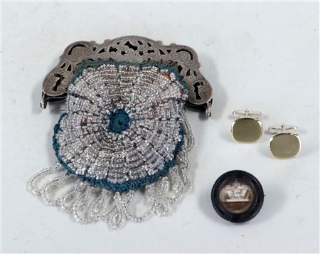 A silver purse with strung beads, accompanied by a pair of silver cufflinks...