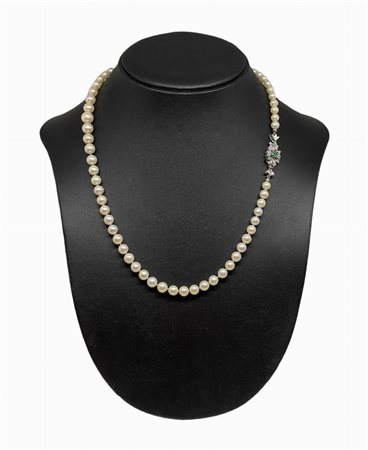 Collana di perle con chiusura in oro bianco e smeraldo centrale.