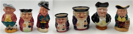 Manifatture inglesi. Serie di sette Toby jug in ceramica policroma (h max cm 19