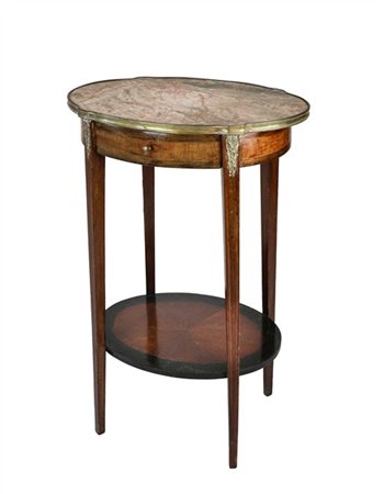 Gueridon di forma ovale in legni vari a due ripiani, un cassetto nella fascia e