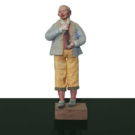 Personaggio presepiale in terracotta e legno con vesti in cotone, raso e passamaneria: : uomo con foulard  e pantaloni gialli, Naples 19° secolo