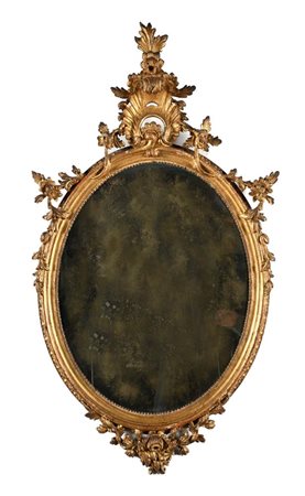 Specchiera ovale in legno dorato, Napoli XVIII secolo sormontata da un...