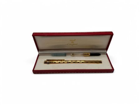 CARTIER Penna a sfera corpo e cappuccio placcati in oro; premendo la parte...