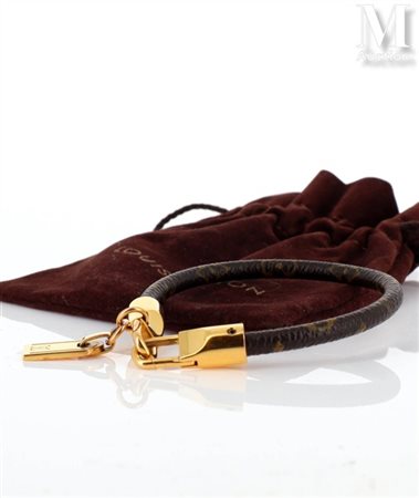 LOUIS VUITTON Bracelet Luck it formé d'un cordon en toile Monogram, fermoir...