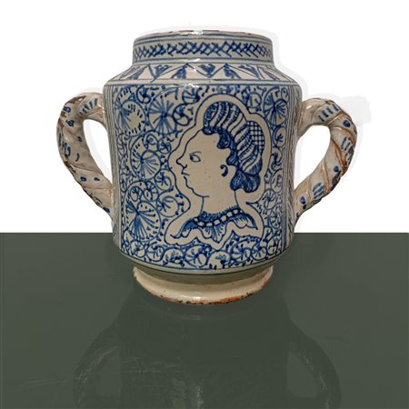 Vaso da farmacia in ceramica con decori blu su fondo bianco e volto di profilo, biansata