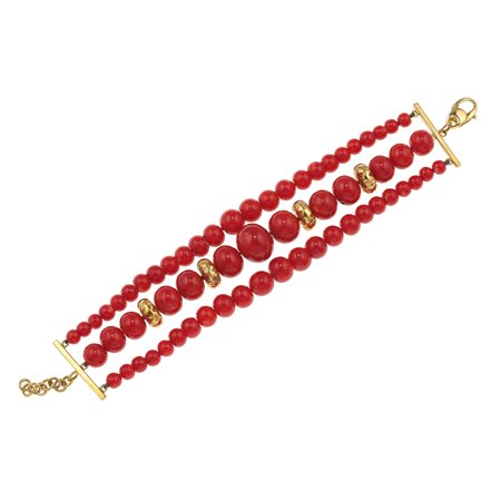 Bracciale con boules di corallo montatura ed inserti in oro giallo 750/1000,...