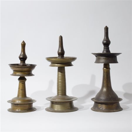 Three votive lamps in bronze