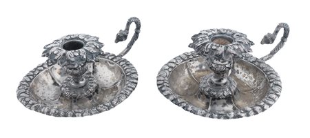 Italia, prima metà XIX secolo, Coppia di portacandele in argento con ricca decorazione a sbalzo. Napoli, 1830. 
