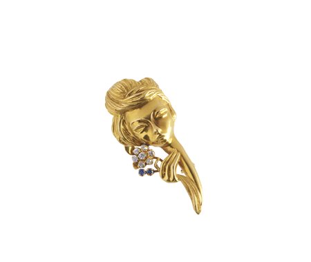 - Spilla artigianale in oro giallo raffigurante volto di donna con diamanti e due piccoli zaffiri.