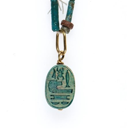 A Restrung New Kingdom faience necklace with an engraved scarab.