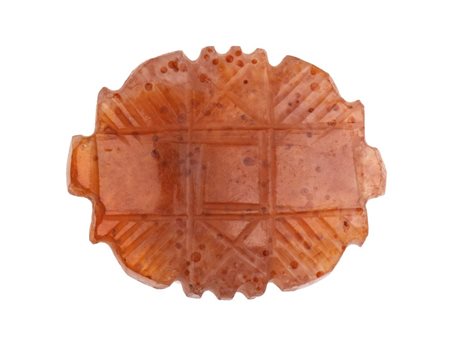A Western Asia carnelian stylized amulet.