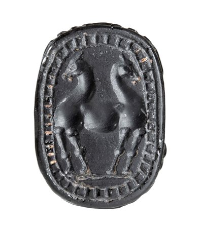 A large black jasper Phoenician engraved scarab.
