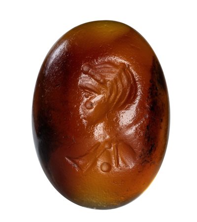 A Roman cabochon carnelian intaglio. Female bust.