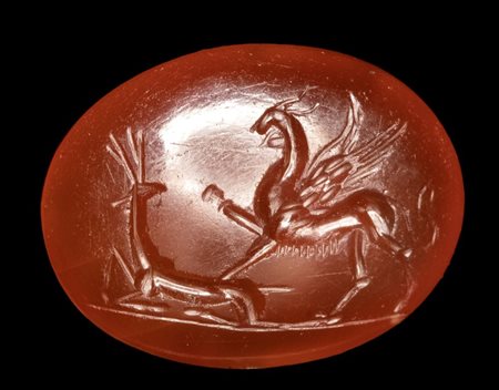 A Roman carnelian intaglio. Griffin with deer.
