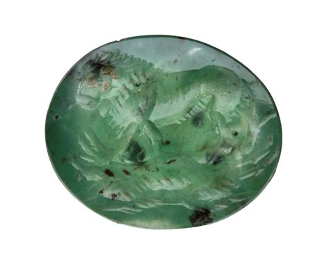 A Roman green chalcedony intaglio. Lion killing a boar.