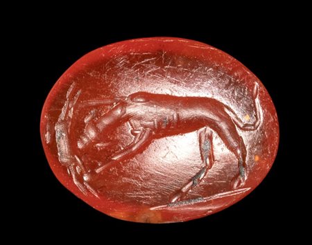A Roman carnelian intaglio. Dog with prey.