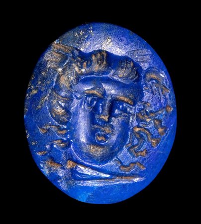 A roman lapis lazuli magical intaglio. Gorgona mask with torch