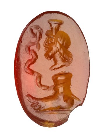 A Roman magical carnelian intaglio. Serapis with foot and snake.