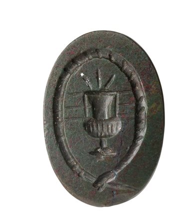 A Roman magical double sided bloodstone intaglio. A vase into an ouroboros with inscriptions.