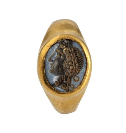 A Roman gold ring set with a nicolo intaglio. Head of Dyonisus.