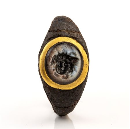 A Roman nicolo intaglio set in a iron and gold ring (restored with silver). Gorgona head.