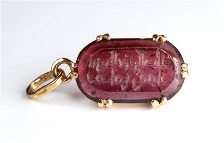 The Seal of the Emir 'Ammar. Tourmaline intaglio with Arabic inscription, set in a later gold pendant
