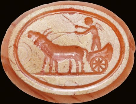 A partially burnt agate intaglio. Erote on a chariot drawn by two goats.