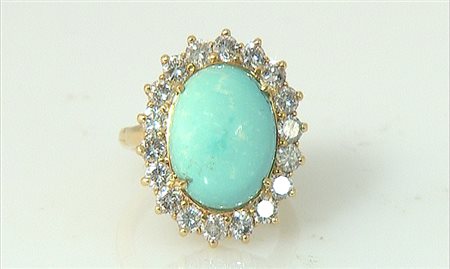 ANELLO ANELLO. In oro giallo 14 kt realizzata a fiore con al centro turchese...