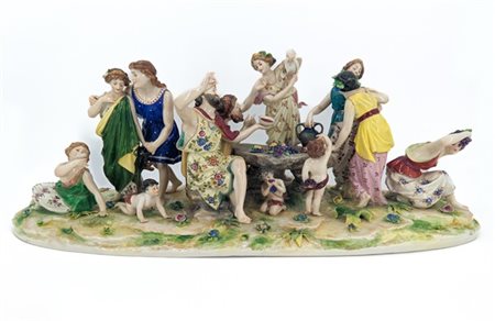 Manifattura del secolo XX. Gruppo in porcellana policroma raffigurante baccanal
