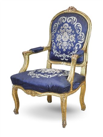 Poltrona in legno intagliato e dorato con cimasa e grembiale decorate a fiori,