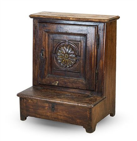 Inginocchiatoio in noce con fronte ad un'anta pannellata e decorata da rosone a